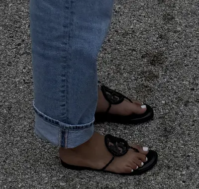 Girls feet in sandals cover image