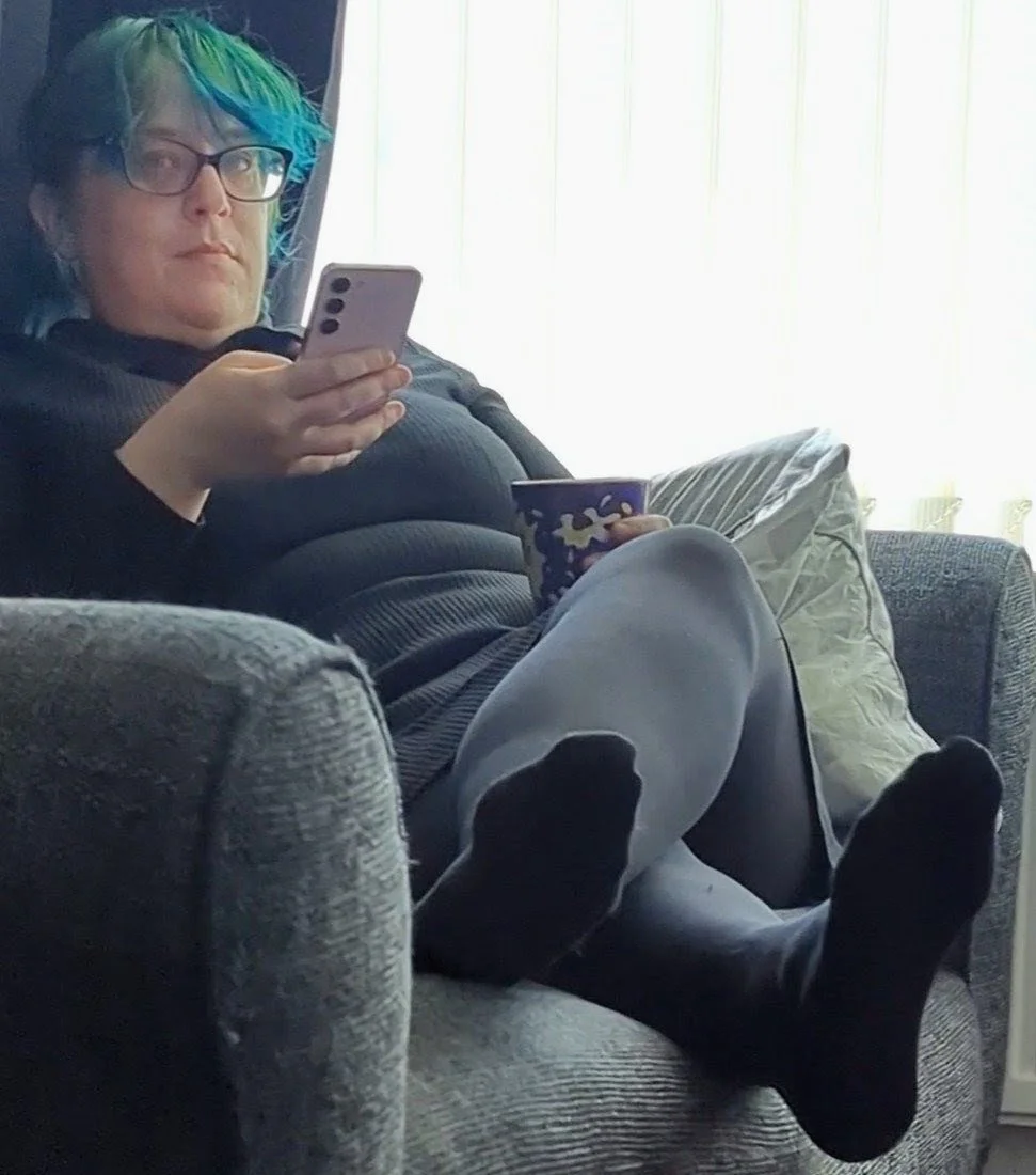 Watching stepmoms pantyhose feet on the couch. She knows and keeps looking over! main image