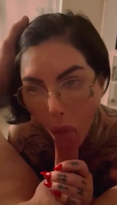 Tattooed bitch sucks cock for cash cover image