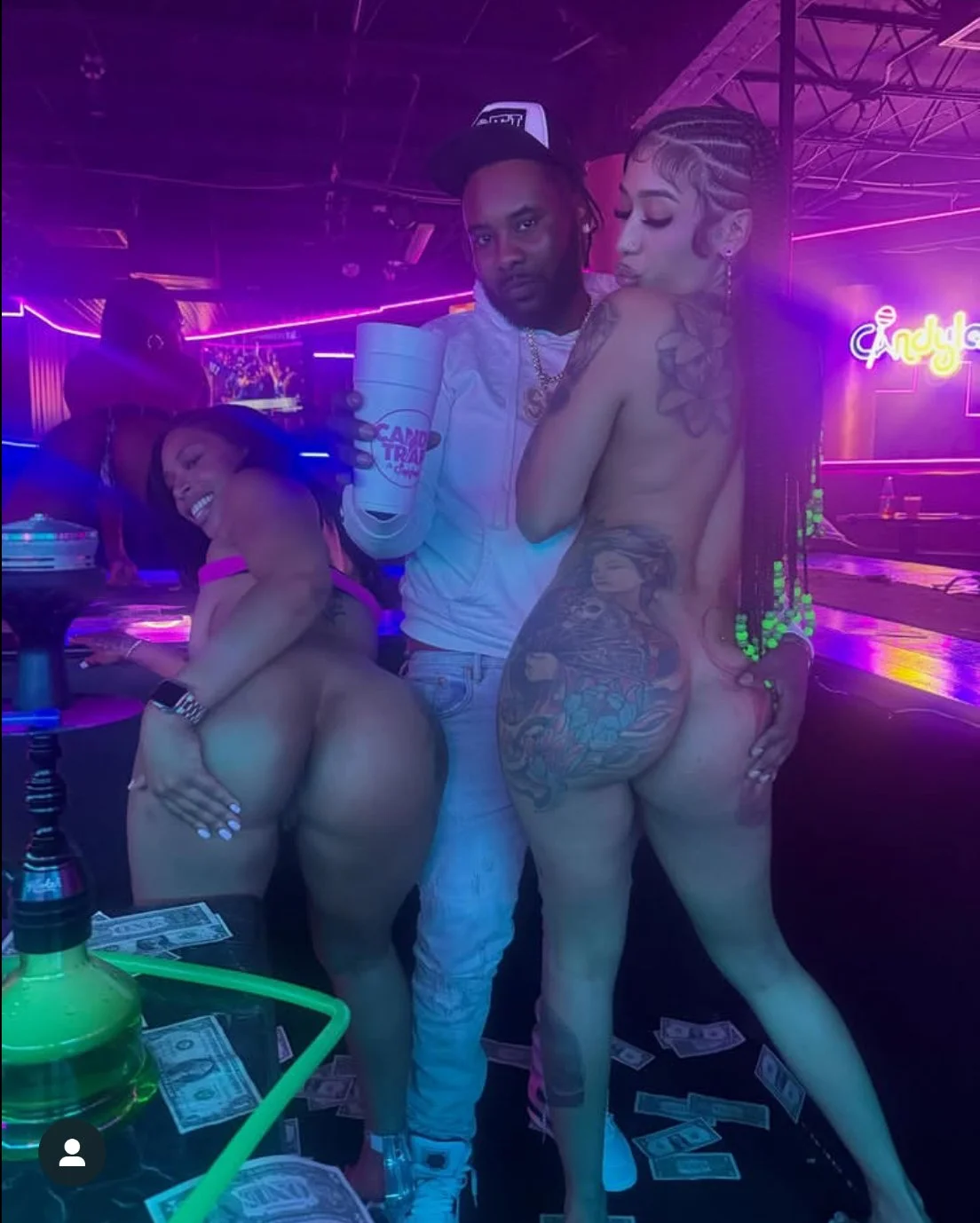 A man is having fun with 2 nude girls at the strip club main image