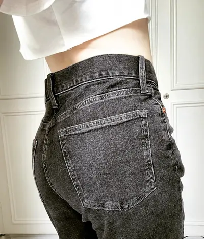 Wearing grey jeans with white crop top cover image