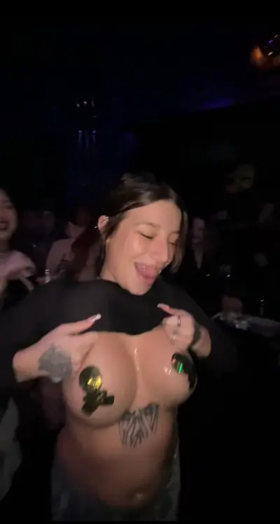 She shows her big boobs public in a nightclub. cover image
