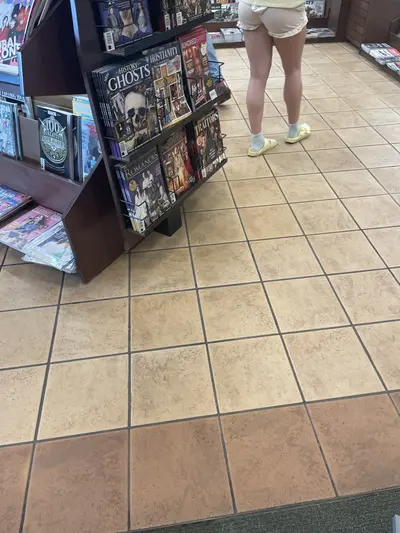 Creepshot of girl at book store cover image