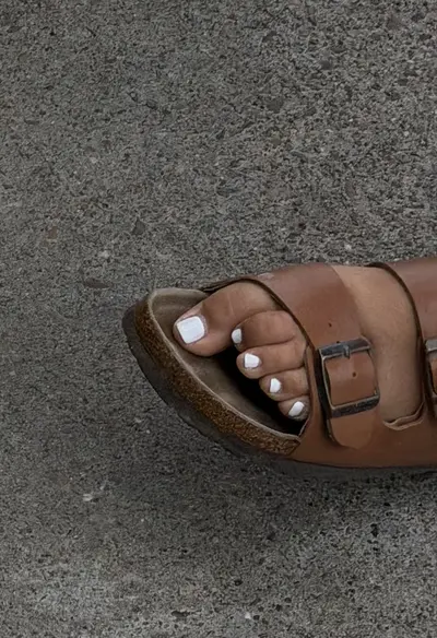 Woman’s feet in sandals cover image