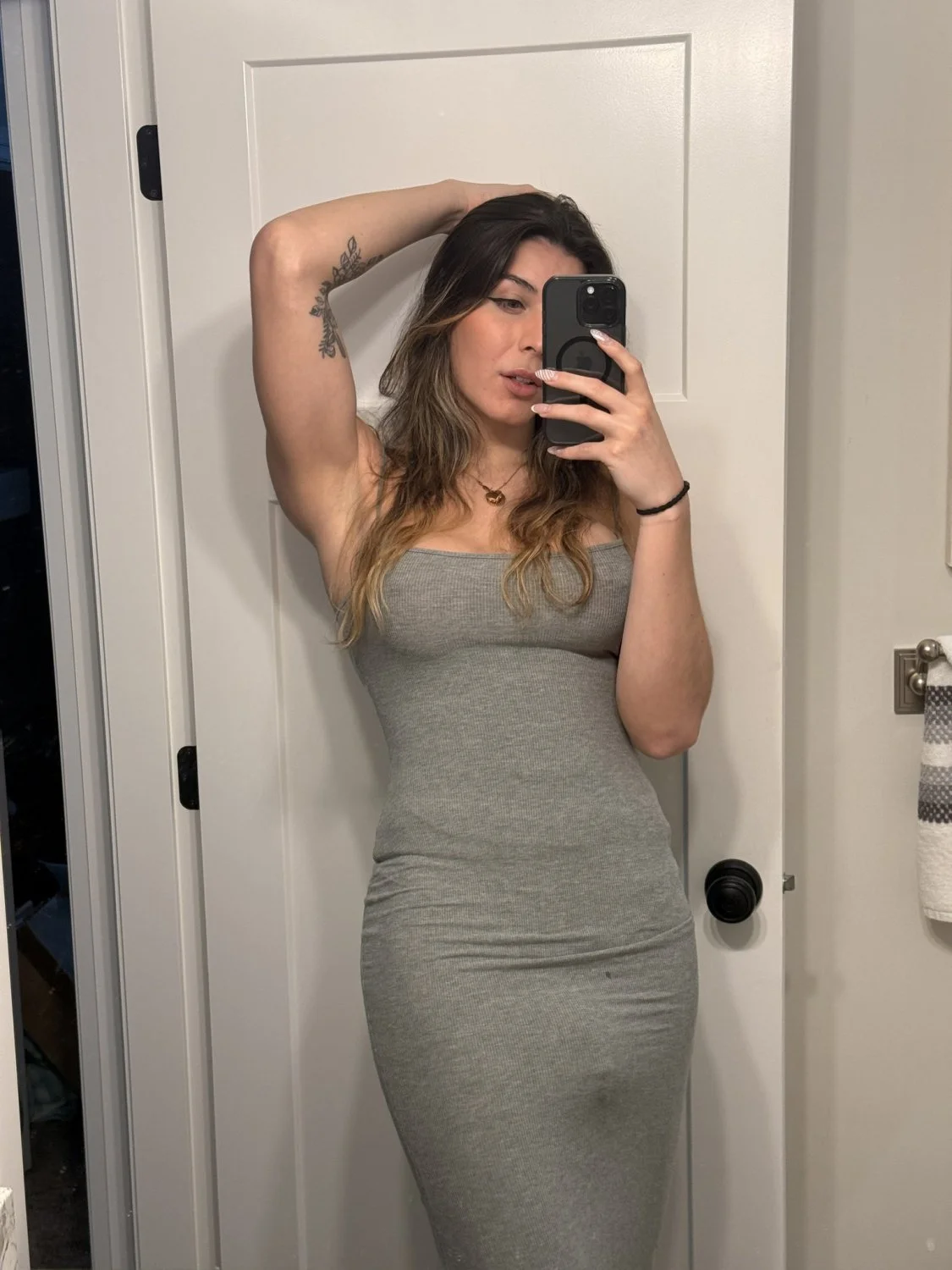 her tight grey dress doesn’t hide much main image