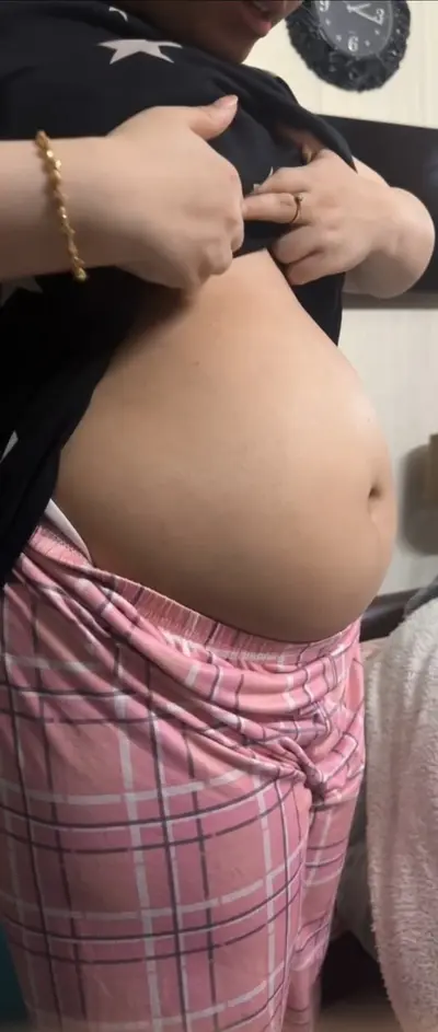 SEXY HOUSEWIFE SHOWS HER PREGNANT BELLY cover image