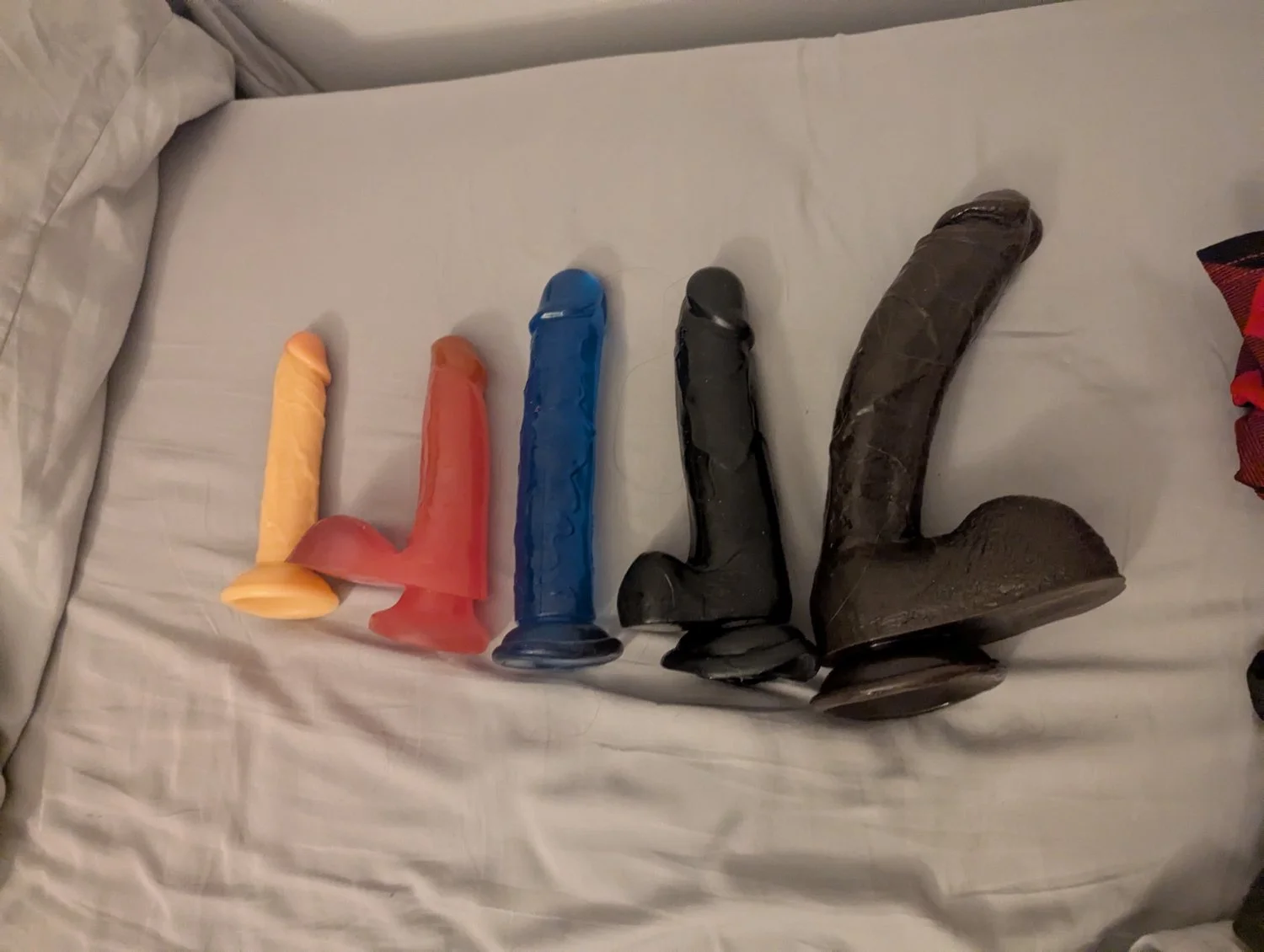Petite flat caged sissy showing off her dildos image 4
