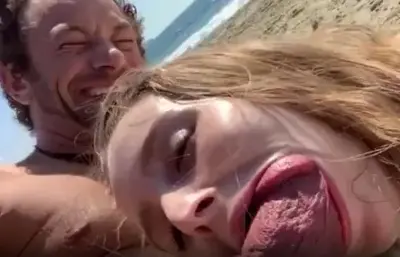 Horny blonde sucking cock in the beach cover image