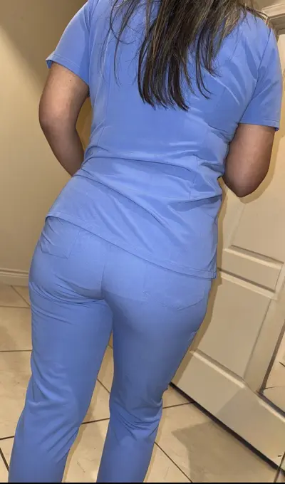 Panty outline visible thru her scrubs cover image