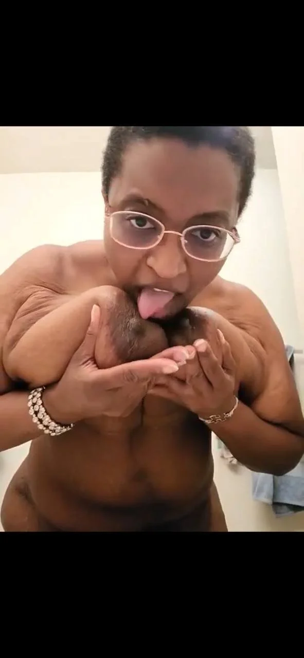 MILF Licking Her Big Tits image 2