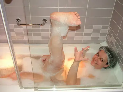 Young wife takes a hot bath cover image