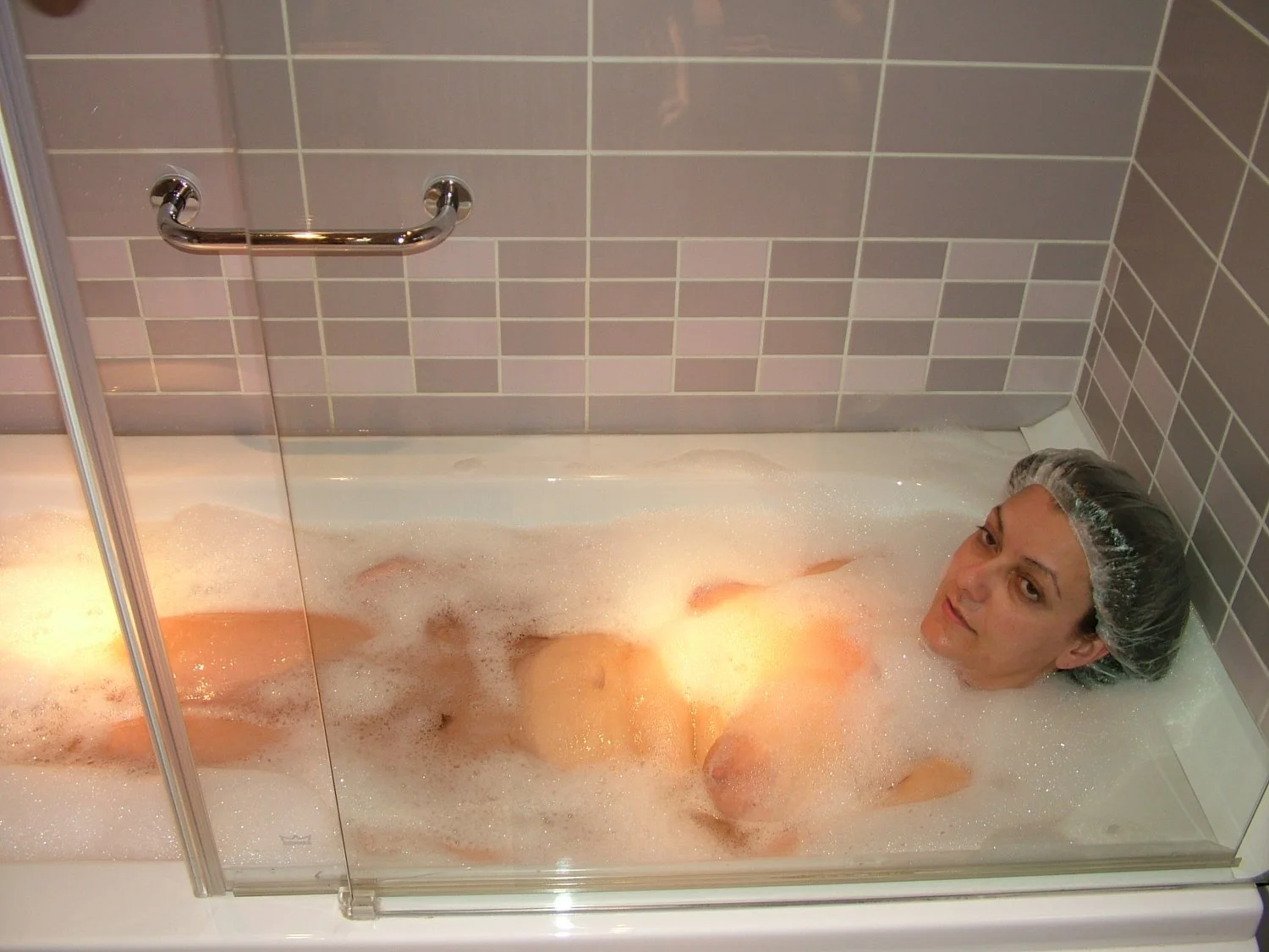 Young wife takes a hot bath image 5