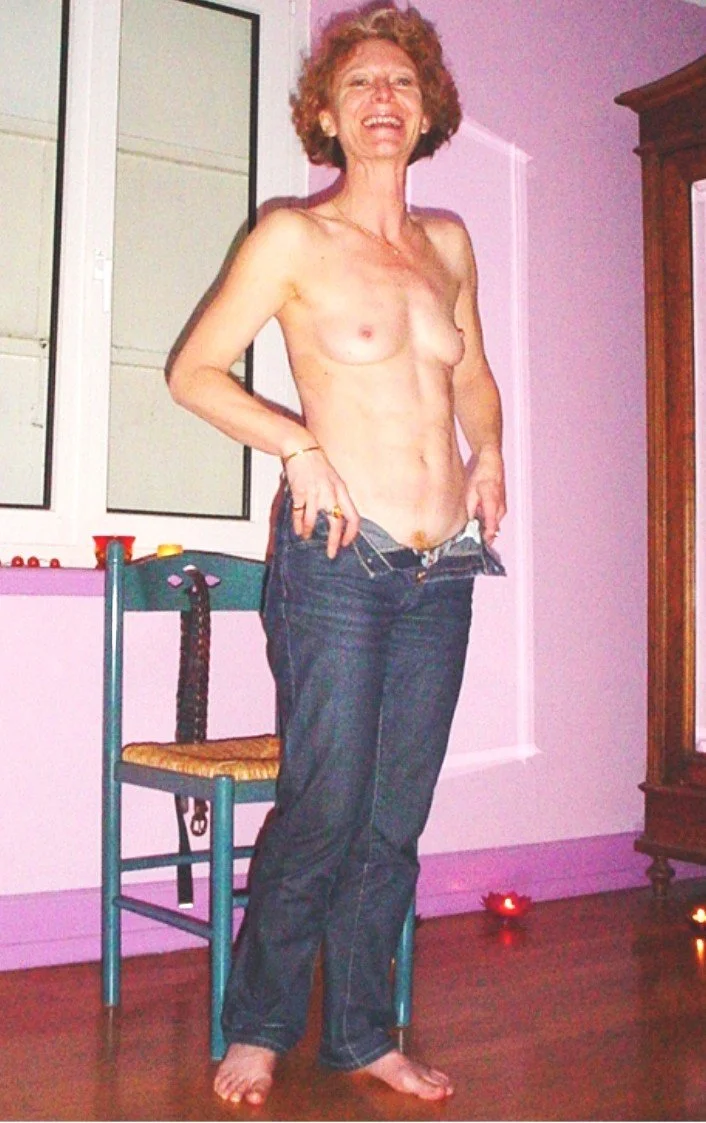 Mature redhead strips image 8