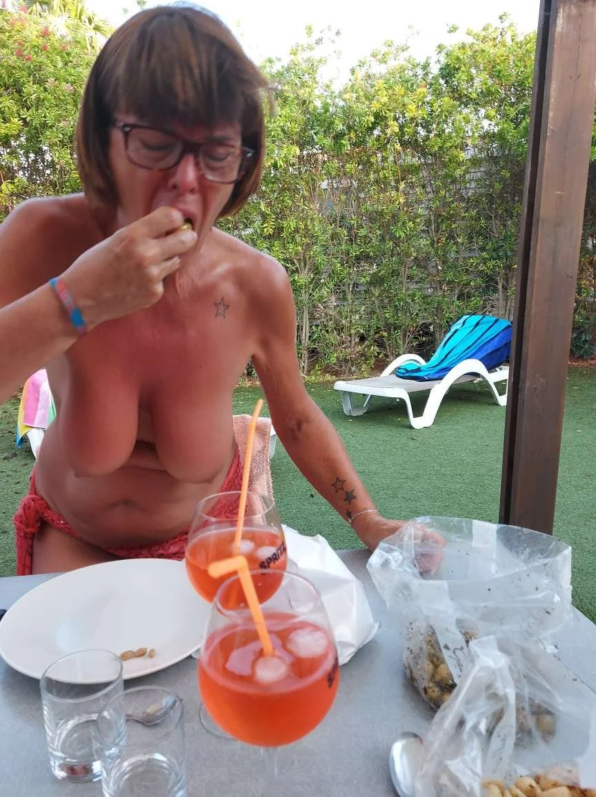 MILF likes to show herself sunbathing in public. image 11