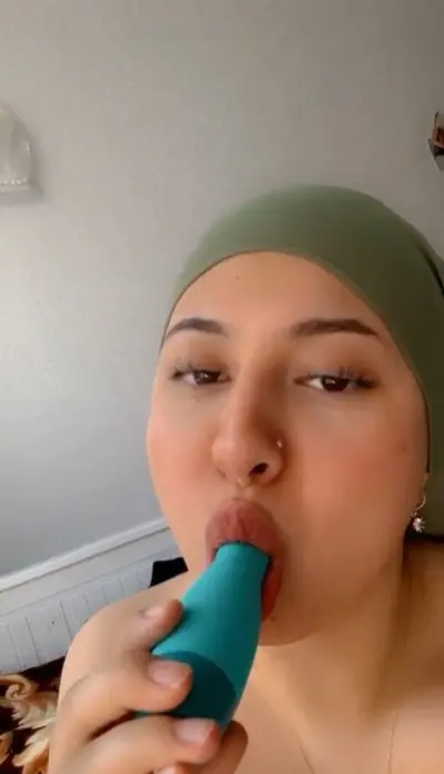 German turkish hijab sucks on toy and fucks her pussy cover image