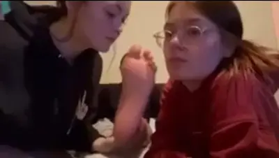 2 girls licking feet cover image