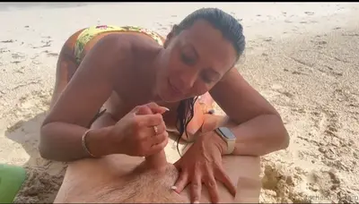 Milf gives an intense blowjob at the beach cover image