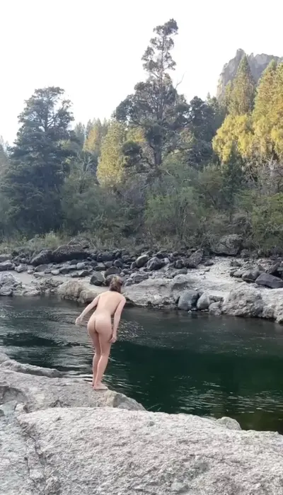 Naked girl dives into water cover image