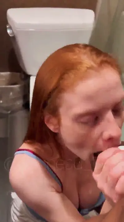 Redhead girl sucking BBC in a bathroom cover image