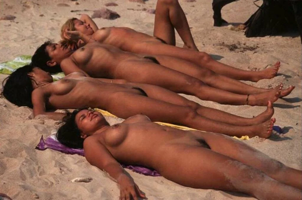 Topless friends at the beach image 39