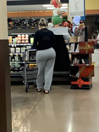 Big ass in grey sweatpants at the store cover image
