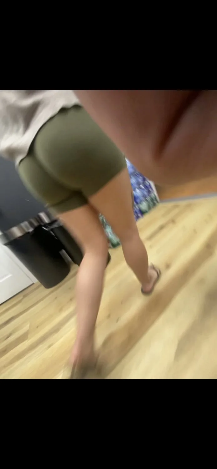 Latina in green biker shorts main image